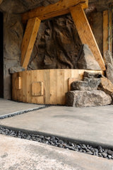 Malawi Panel mounted against back corner walls of wooden hot tub with rock steps