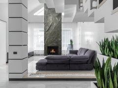 Modern Living Room With Large Black Couch and Fireplace. Slate Wall Panel Covering Fireplace Wall and Chimney Stack 